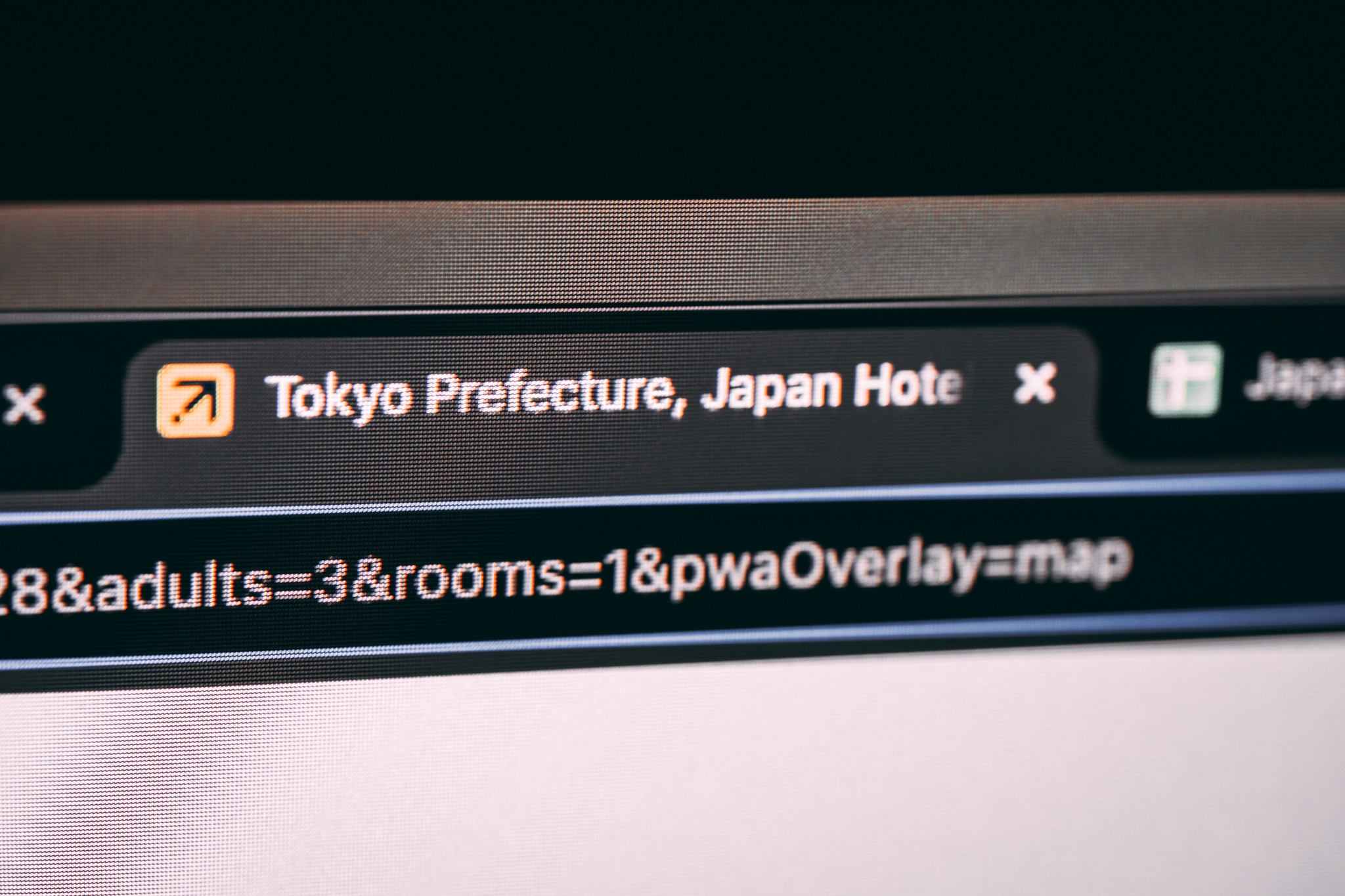 A computer screen displaying a web browser with a tab titled Tokyo Prefecture, Japan Hotels and a URL bar showing search parameters for adults and rooms