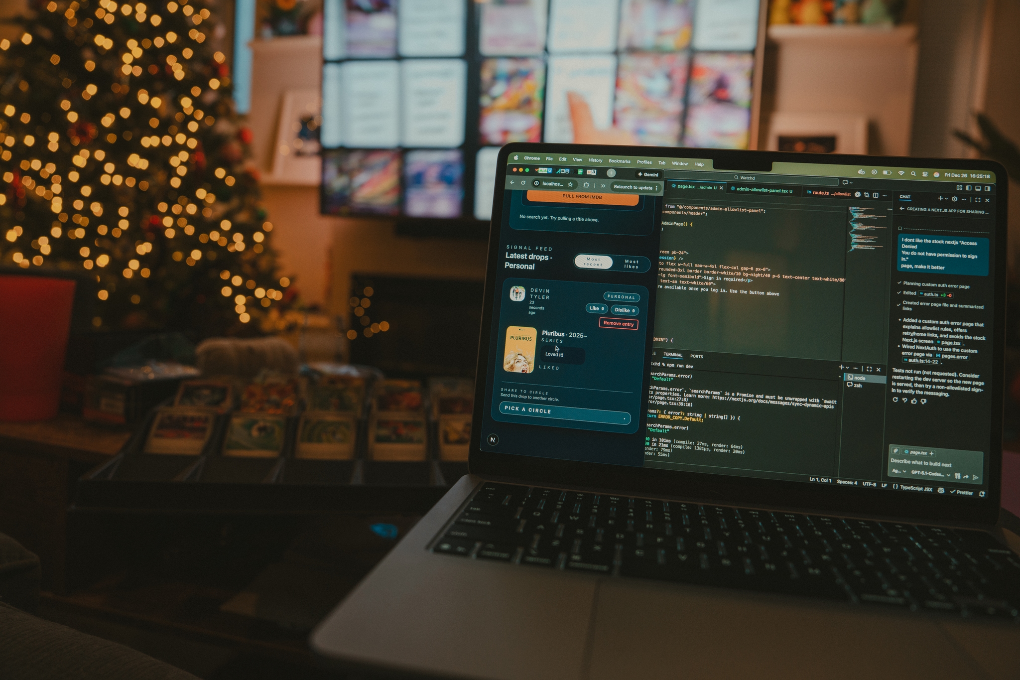 Open laptop displaying code on a cozy living room table with trading cards in the foreground, a lit Christmas tree on the left, and a television screen in the background