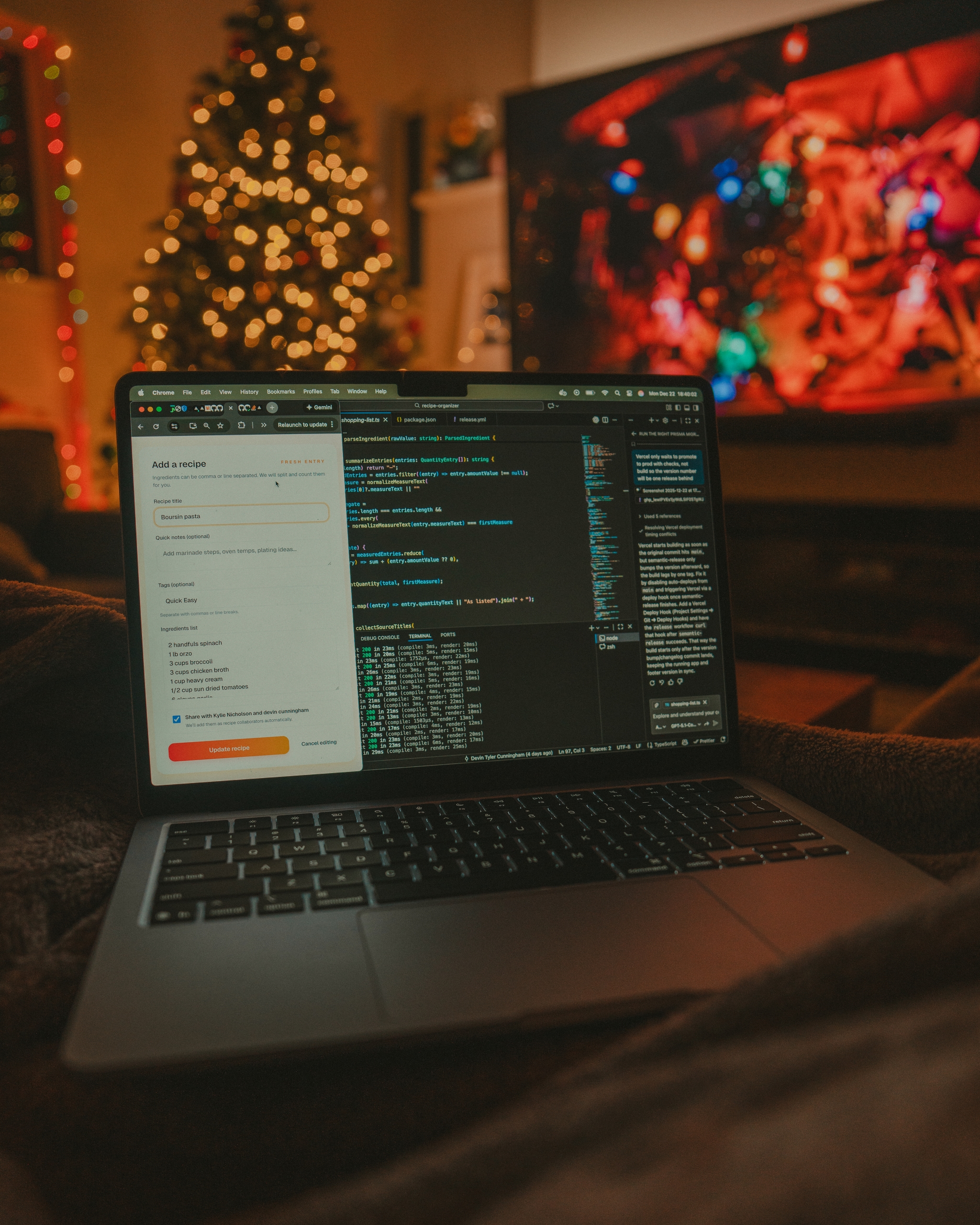 Open laptop displaying code in a dimly lit living room with a glowing Christmas tree and colorful TV screen in the background, creating a cozy holiday work atmosphere