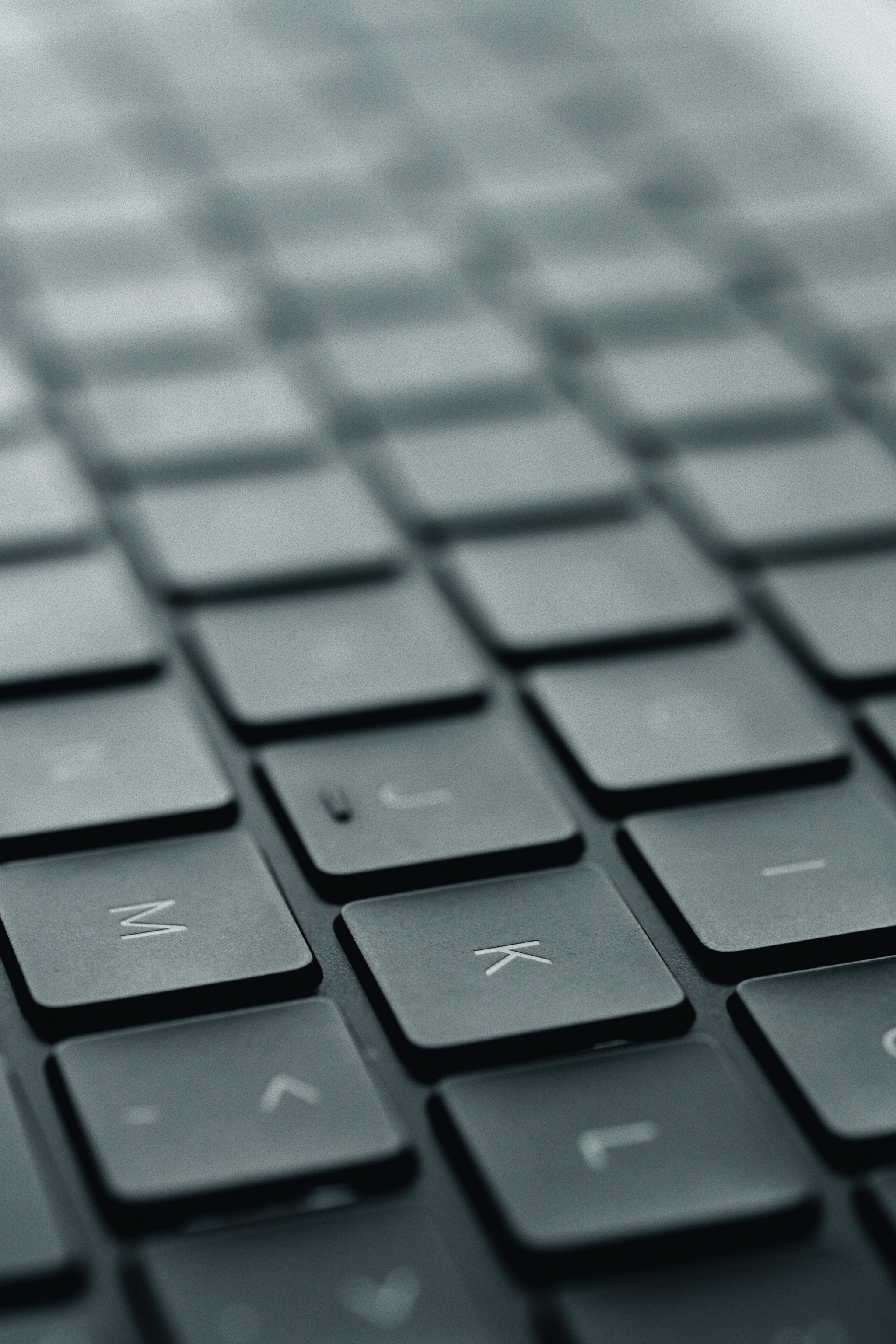 A close-up view of a black computer keyboard with a shallow depth of field, focusing on the keys