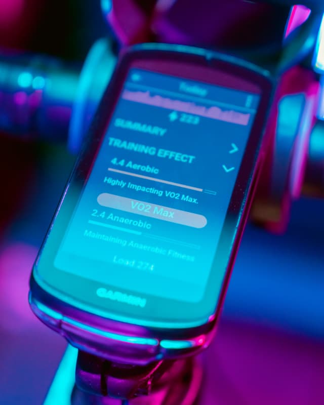 Garmin device displaying cycling performance data with colorful lighting effects