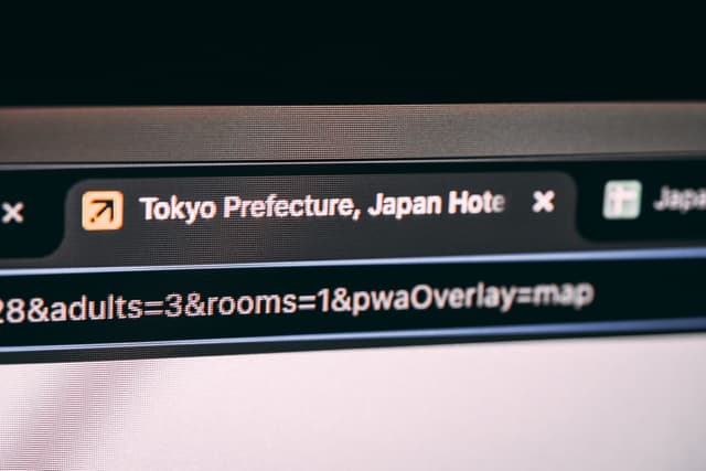 A computer screen displaying a web browser with a tab titled Tokyo Prefecture, Japan Hotels and a URL bar showing search parameters for adults and rooms