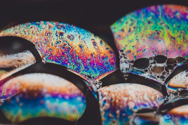 Colorful soap bubbles with iridescent patterns and reflections
