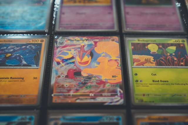 A collection of trading cards in protective sleeves, featuring colorful designs and illustrations