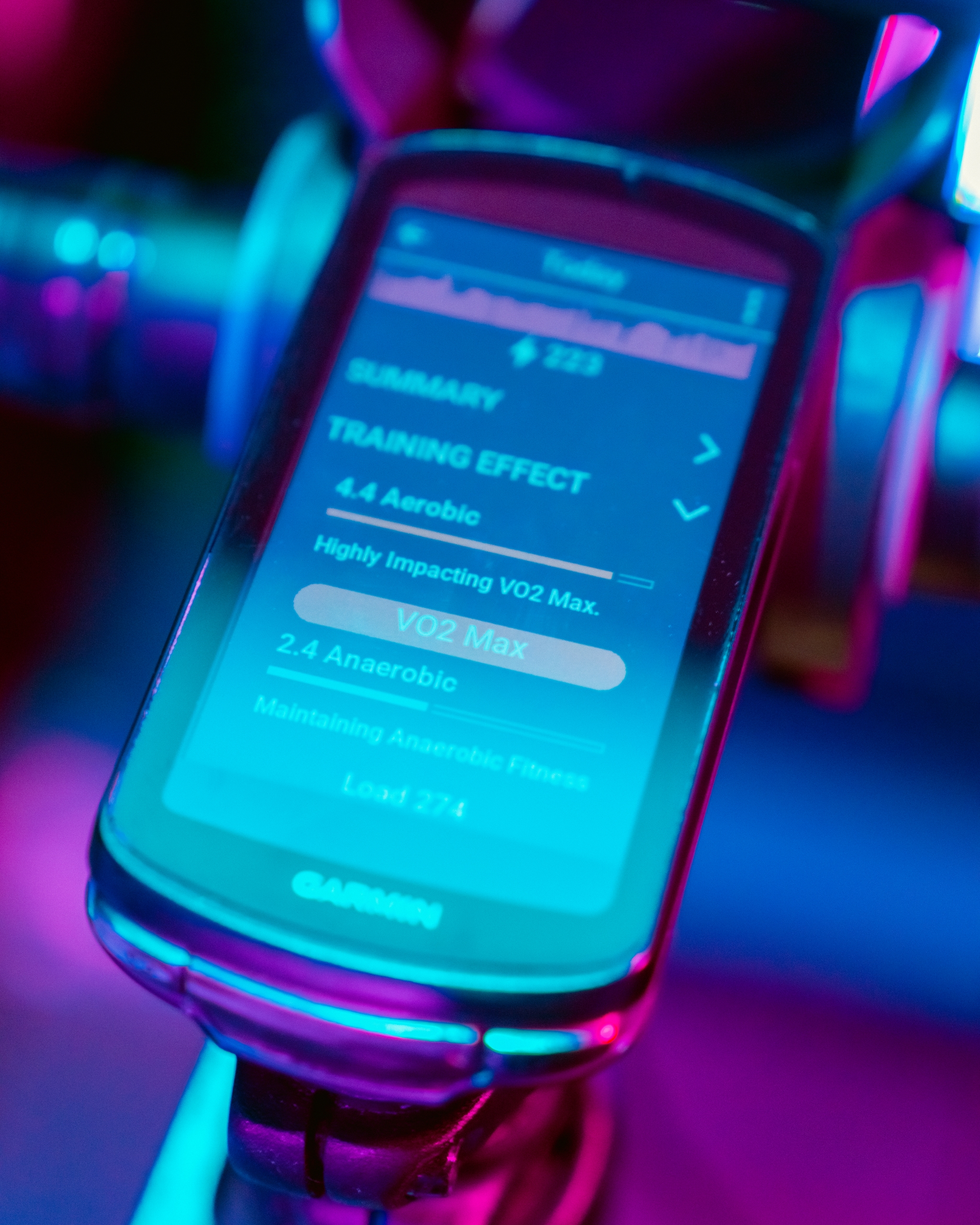 Garmin device displaying cycling performance data with colorful lighting effects